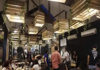a crowd of people standing in a restaurant with tables at Ortigas Budget Hotel - Kapitolyo in Manila