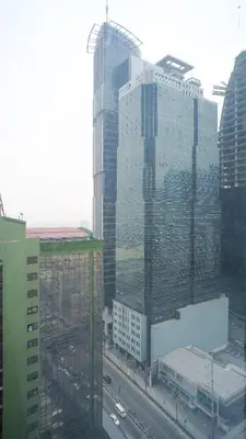 a view of a city with tall buildings and a highway at Currency Serviced Suites in Manila