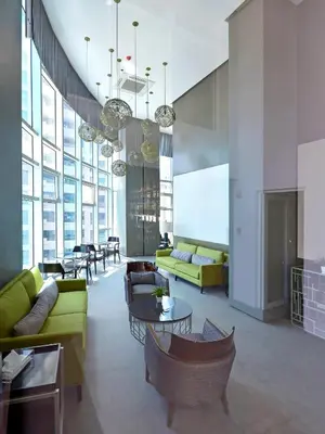 a living room with couches and tables in a building at Currency Serviced Suites in Manila