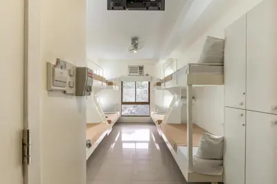 a room with two bunk beds and a window at Selah Garden Hotel Manila in Manila