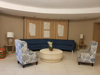 a living room with a blue couch and two chairs at 1Bedroom with Balcony in Manila