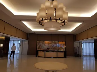 a large lobby with a table and a chandelier at 1Bedroom with Balcony in Manila