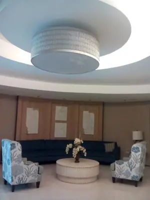 a living room with a ceiling with a large light at 1Bedroom with Balcony in Manila