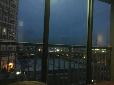 a view of a city at night from a balcony at ORTIGAS 2 Br Corner Unit With 2 Queen Across Shangrila in Manila