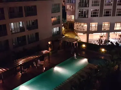 a pool in the middle of a building at night at ORTIGAS 2 Br Corner Unit With 2 Queen Across Shangrila in Manila