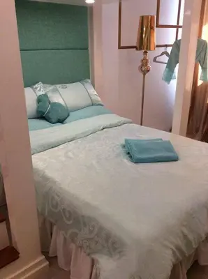 a bed with two pillows on top of it at Tiffany Room At Shell Residences in Manila