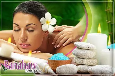 a woman in a spa tub with a flower on her head at Tiffany Room At Shell Residences in Manila