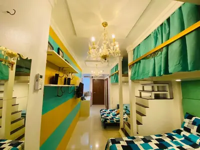 a room with two bunk beds and a chandelier at Tiffany Room At Shell Residences in Manila