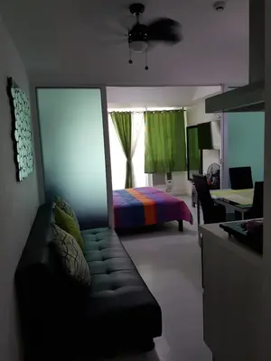 a living room with a couch and a bed at Azure Tropical Paradise in Manila