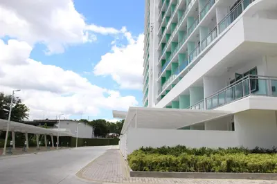 a white building with a balcony on the side of it at Azure Tropical Paradise in Manila