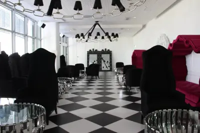 a room with black chairs and a checkered floor at Azure Tropical Paradise in Manila