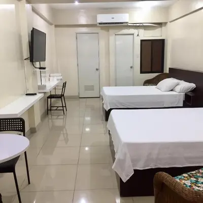 a hotel room with two beds and a tv at RESIDENCIA SAN VICENTE - PASAY -Budget Hotel in Manila