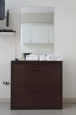 a wooden cabinet with towels on top of it in a kitchen at RESIDENCIA SAN VICENTE - PASAY -Budget Hotel in Manila