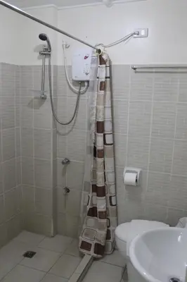 a bathroom with a shower with a toilet and a sink at RESIDENCIA SAN VICENTE - PASAY -Budget Hotel in Manila