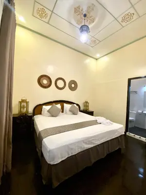 a bedroom with a bed and two clocks on the ceiling at Park Avenue Boutique Hotel Manila in Manila