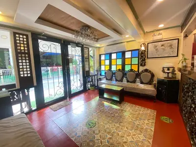 a living room with a couch and some windows at Park Avenue Boutique Hotel Manila in Manila