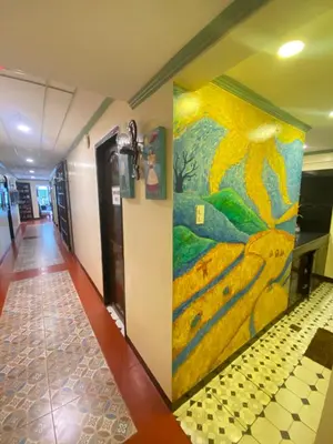 a painting on the wall of a hallway at Park Avenue Boutique Hotel Manila in Manila