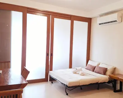 a room with a bed and some glass windows at MANILA BAYVIEW RENTAL- LUXURY AND SUPERIOR 1 - 5 BEDROOM CONDOS WITH BALCONY POOL BAYVIEWS NETFLIX - Housekeeping Available- in Manila