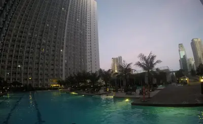 a large pool of water in a city with tall buildings at Linda's Condo in Manila