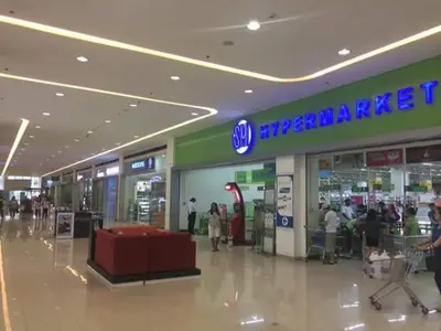 a shopping mall with people walking around in a store at Linda's Condo in Manila