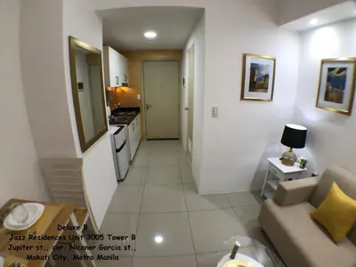 a small living room with a couch and a kitchen at Jazz Makati Luxury Apartment in Manila