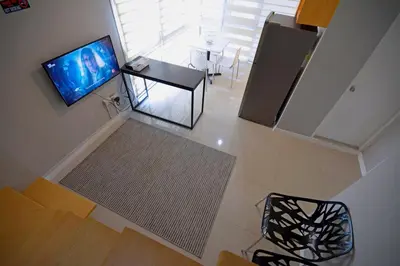 an overhead view of a living room with a television and a table at Victoria SOHO Suites in Manila