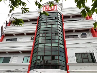 a building with a sign on the side of it at N&J Lopez Lodging House in Manila