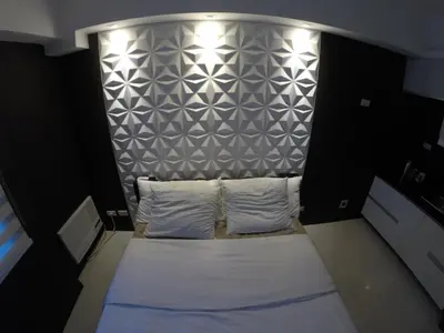 a bed with two white pillows in a room at Burgundy McKinley Place Service Apartment in Manila