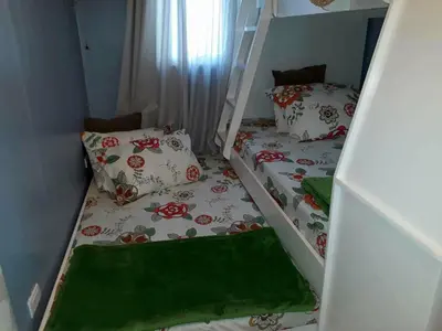 two twin beds in a room with two bunk beds at Sorrel Residences Condo Apartment by Fe in Manila