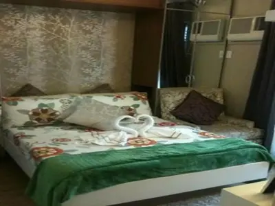 a bedroom with a bed with a swan on it at Sorrel Residences Condo Apartment by Fe in Manila