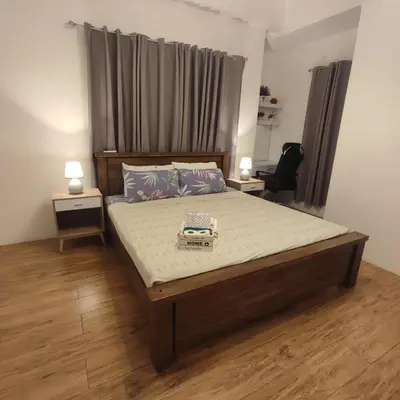 a bedroom with a large bed with two night stands at Luxury spacious 2BR in Salcedo Village in Manila