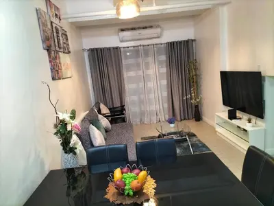 a living room with a couch and a television at Luxury spacious 2BR in Salcedo Village in Manila