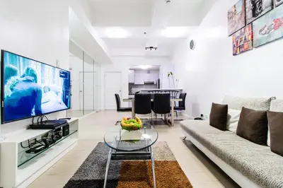 a living room with a couch and a tv at Luxury spacious 2BR in Salcedo Village in Manila