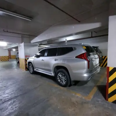a silver suv parked in a parking garage at Luxury spacious 2BR in Salcedo Village in Manila