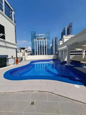 a swimming pool with a city skyline in the background at Luxury spacious 2BR in Salcedo Village in Manila