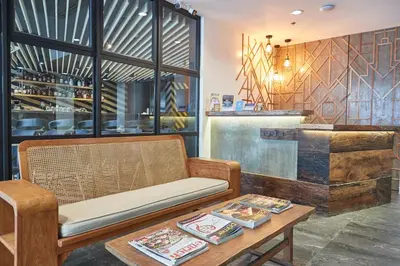 a room with a bench and a table and a counter at 5880 Enriquez Residences in Manila