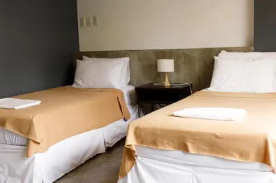 two beds sitting next to each other in a room at 5880 Enriquez Residences in Manila