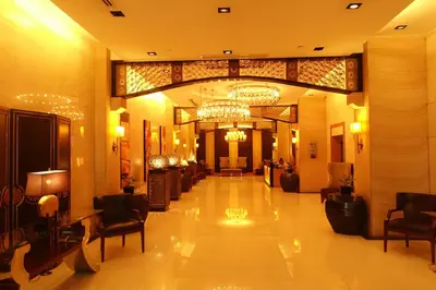 a lobby of a hotel with a chandelier at Modern Asian Condo at Forbeswood Parklane The Fort BGC in Manila