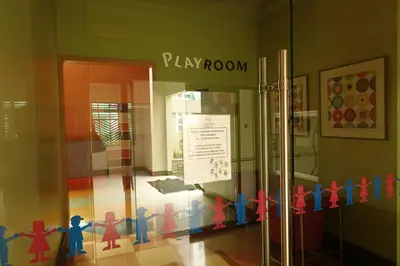 a window of a play room with toy people on it at Modern Asian Condo at Forbeswood Parklane The Fort BGC in Manila