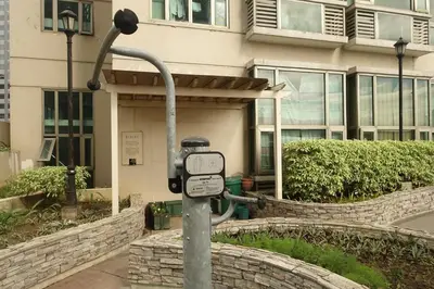 a parking meter in front of a building at Modern Asian Condo at Forbeswood Parklane The Fort BGC in Manila