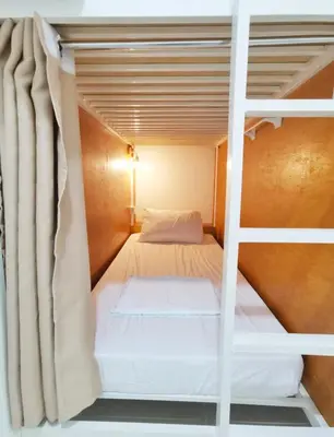 a bedroom with a bunk bed in a room at Nomads MNL Backpackers Homestay - near Airport in Manila