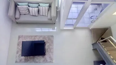 a living room with a couch and a tv at Affordable Makati APT in Manila