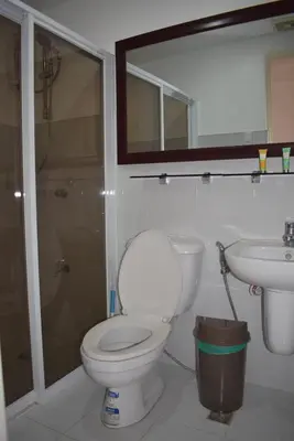 a bathroom with a toilet and a sink at Affordable Makati APT in Manila