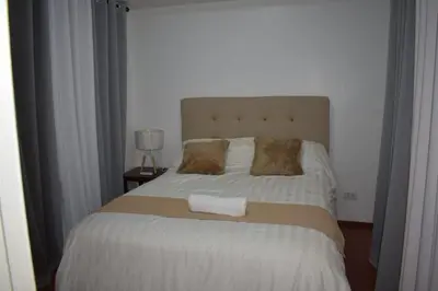 a bedroom with a large bed with a white blanket at Affordable Makati APT in Manila