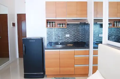 a kitchen with a refrigerator and a sink at Affordable Makati Serviced Apartments in Manila
