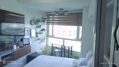 a room with a bed and a window and a table at Sm Mezza Residences in Manila