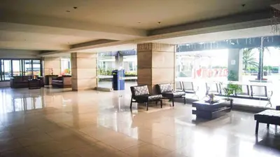 a lobby with chairs and tables in a building at Sm Mezza Residences in Manila