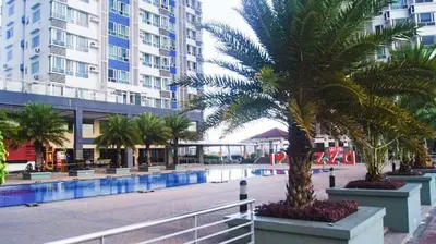 a street with palm trees and a building at Sm Mezza Residences in Manila