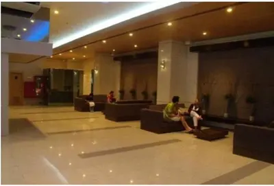 two people sitting on couches in a lobby at Sm Mezza Residences in Manila