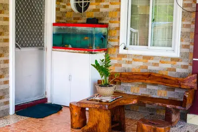 a room with a table and a fish tank at Entire House with 4 rooms near SM Molino and Vermosa Ayala in Imus